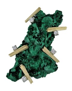 Photo courtesy Llyn L. Strelau Entitled 'Kryptonite,' this lapel pin features 18-karat yellow gold wire straws holding a mineral specimen of chatoyant malachite set off by round brilliant diamonds.