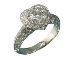 Photo courtesy Llyn L. Strelau 'Heartfelt' halo setting for heart-shape diamond. The metal takes a 'back seat' to the diamonds' brilliance. The beads for the pavé can be more delicate and subtle than would be necessary with white gold and the stones are set very securely.