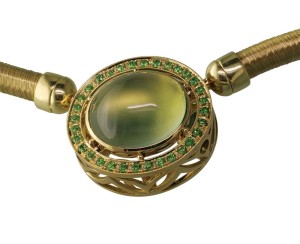 Photo courtesy Llyn L. Strelau A green gold pendant featuring a bezel-set prehnite with demantoid garnets.