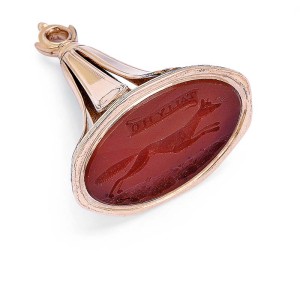 Photo courtesy Dupuis Fine Jewellery Auctioneers 'Tally Ho,' a 10-karat gold pocket watch fob seal, with hunting motif featuring a carved fox carnelian intaglio. Circa 1880s.