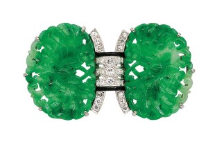 Photo courtesy Dupuis Fine Jewellery Auctioneers Platinum and 18-karat gold art deco brooch with jadeite plaques carved as a pair of butterflies amongst flowers, centring a diamond-set arch accented by black enamel.