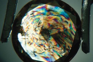 Photo courtesy Mark T. Cartwright The combination of the non-Type IIa anomalous double refraction pattern and the presence of transparent crystal inclusions is sufficient to determine the natural origin of this diamond.