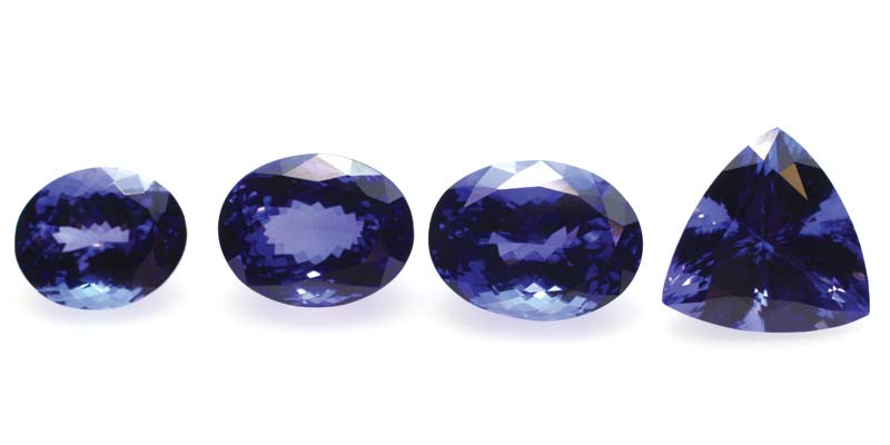 Photo courtesy CGL. Photo by Bryan Delos Reyes. Four tanzanites ranging in colour from lighter violet-blue (8.43 carats far left) to dark bluish-violet (14.23-carats far right).