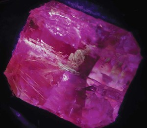 Photo courtesy Mark T. Cartwright Some types of 'oil' used to fill fractures in emeralds fluoresce yellow to ultraviolet light and a 405 nm laser, as shown in this image. Extreme caution must be exercised when using any laser to prevent irreversible damage to your eyes.