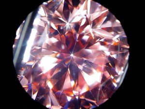 Photo courtesy Mark T. Cartwright This natural diamond shows evidence of a pink coating on the pavilion; note it is most easily seen in the reflection of the culet rather than directly. Detection of coated diamonds, especially melee, can be time-consuming and requires us to be very suspicious of anything that seems 'incorrect' about the colour distribution in a fancy-coloured diamond.