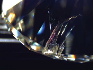 Photo courtesy AGSL. Photo by Jen Tobiasson. Fracture-filling a diamond can make it more salable. When undisclosed, it can erode consumer confidence. This treatment exhibits a pinkish-orange flash effect in this stone.
