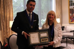 CJA past chair Tanya Parrish accepts the Erol Paylan Memorial Award from incoming chair Marco Miserendino.