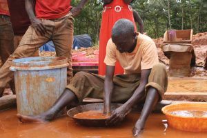 A miner in Tanzania mixes mercury and gold.