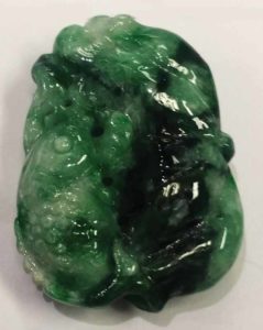 This jade variety is known as flower green because the base is pea green and the patches of black inclusions look like flowers. Pea varieties have opaque green and white round spots that look like snow peas.