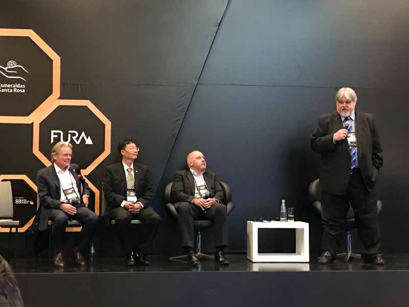 Photo courtesy Cynthia Unninayar The Gemological Institute of America’s (GIA’s) Shane McClure (right) led a panel discussion on origin, with Claudio Milisenda (DSEF), Taijin Lu (NGTC), and Kenneth Scarratt (DANAT).