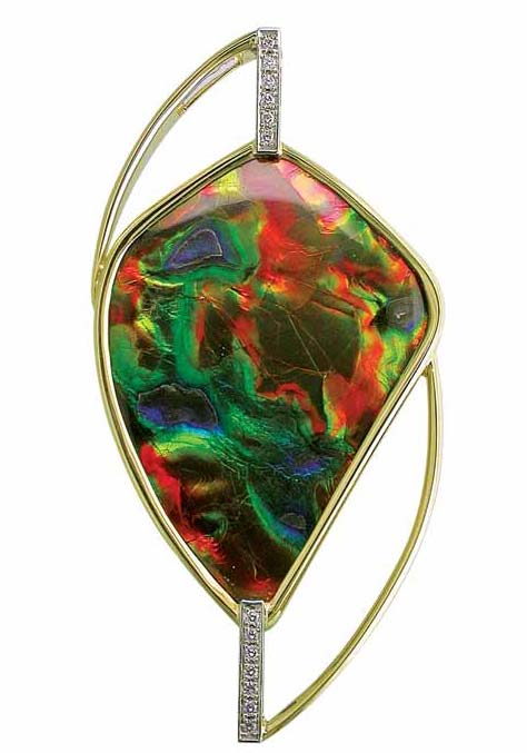 Photos courtesy Llyn Strelau An 18-karat yellow gold and 19-karat white gold pendant with bezel-set freeform ammolite, accented with pave-set round brilliant-cut white diamonds.