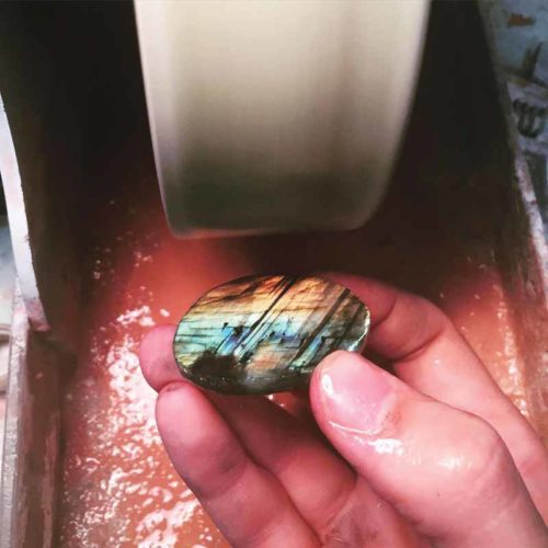 Labradorite from Labrador being cut into a cabochon.