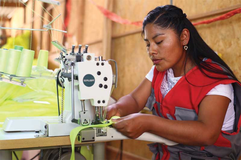 Many employees of a Fairtrade gold mine in Peru are now able to produce safety workwear instead of scraping around, looking for gold in waste mining tailings. Photo courtesy Alan Frampton/MacDesa