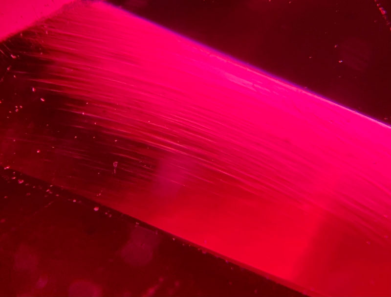 Curved lines in synthetic ruby, created using the flame fusion (or Verneuil) method.