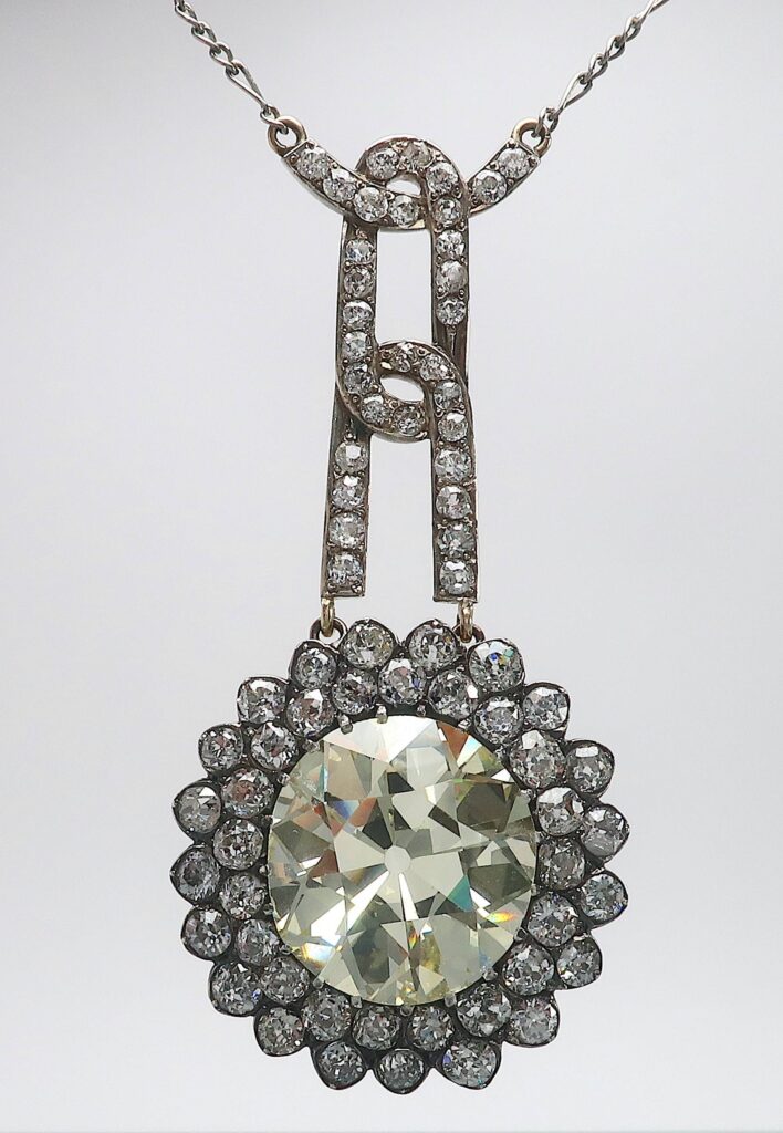 A diamond necklace with a sun-shaped diamond pendant.
