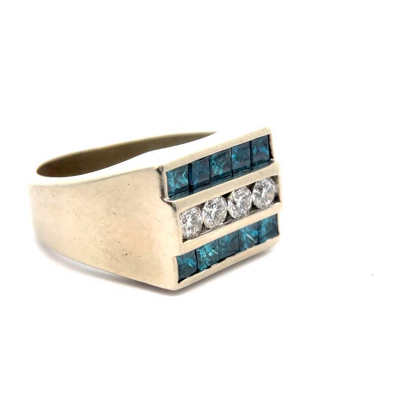 A close-up of a white gold men's ring with inlaid white and blue diamonds.