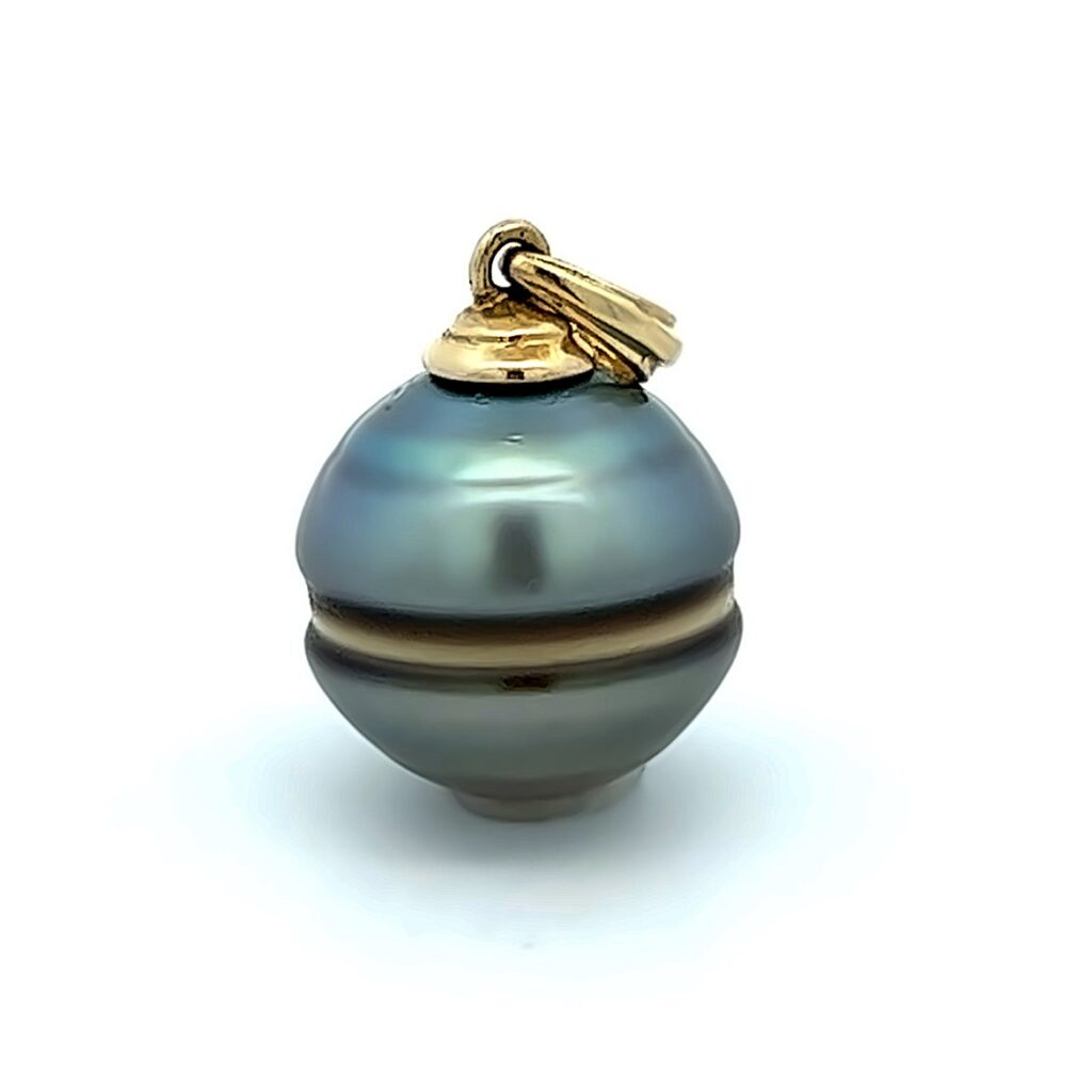 Close-up of an aquamarine-coloured pearl pendant.