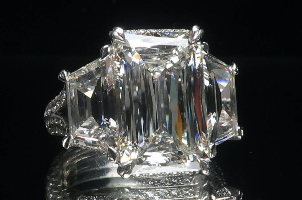 A gargantuan square diamond ring with a black background.