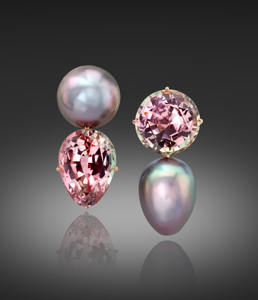Pair of pearl and tourmaline earrings with the one on the left upside-down.