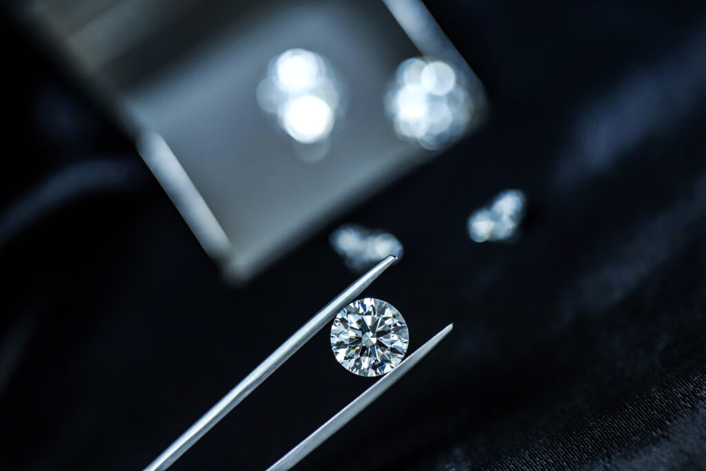 Close-up of a diamond being held with tweezers.