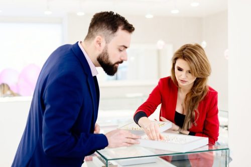 Young couple look at rings in a jewellery store