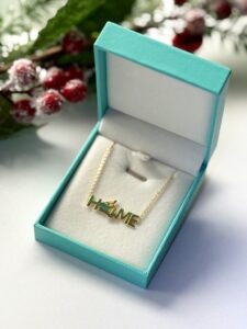 Gold necklace inside an opened gift box.