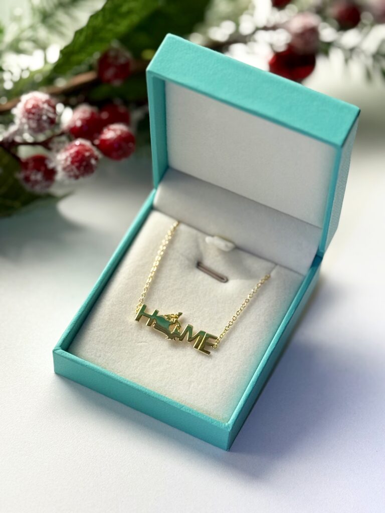 Gold necklace inside an opened gift box.