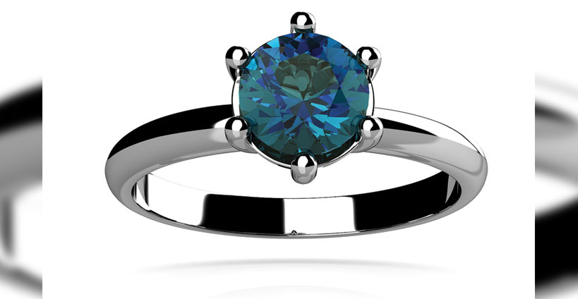 Silver ring with blue gemstone.