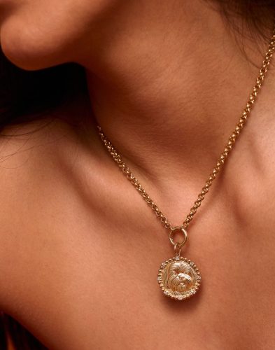 model wears gold medallion