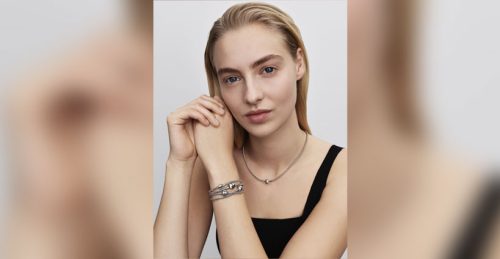 A model wears Pandora bracelets and a necklace.