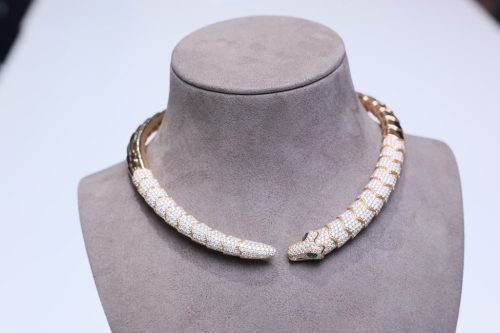Ouroboros-style gold and diamond necklace on display.