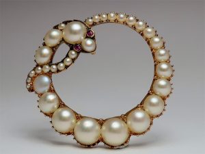 round snake-like brooch made of antique pearls