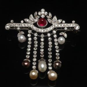 brooch with pearls and ruby in the middle