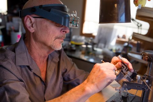 man examining ring in lab