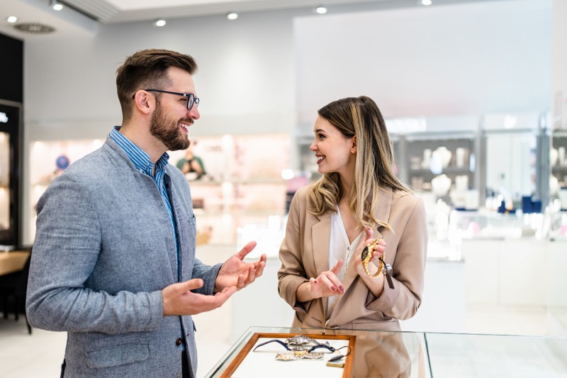 man and woman talking in jewellery store