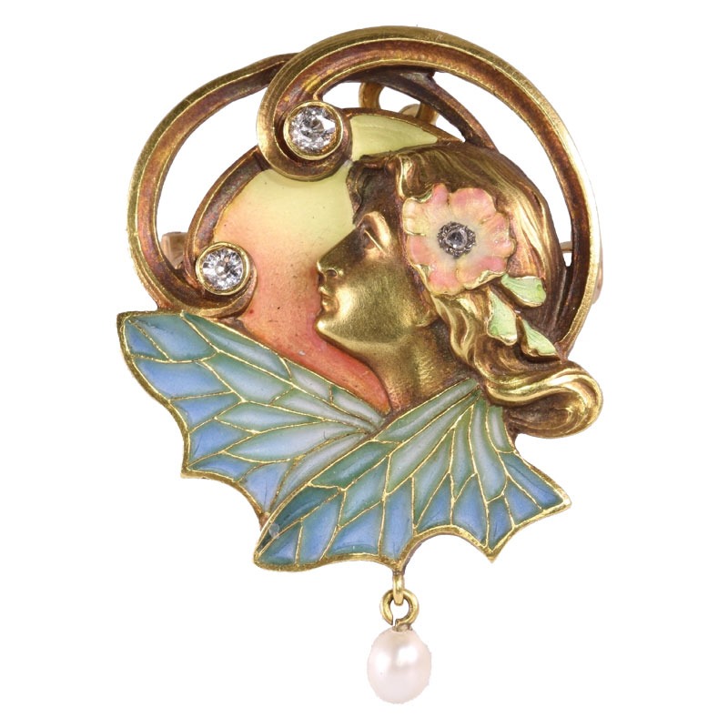 Gold Art Nouveau brooch of a woman's profile with flowing hair, a flower, diamond accents, blue-green enamel wings, and a dangling pearl.