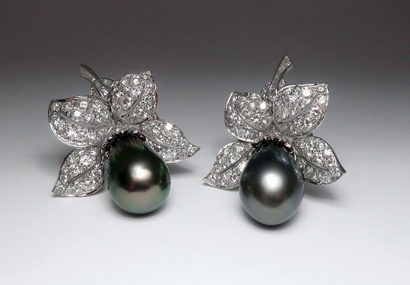 A pair of platinum, diamond, and black pearl earrings, ca. 1990.